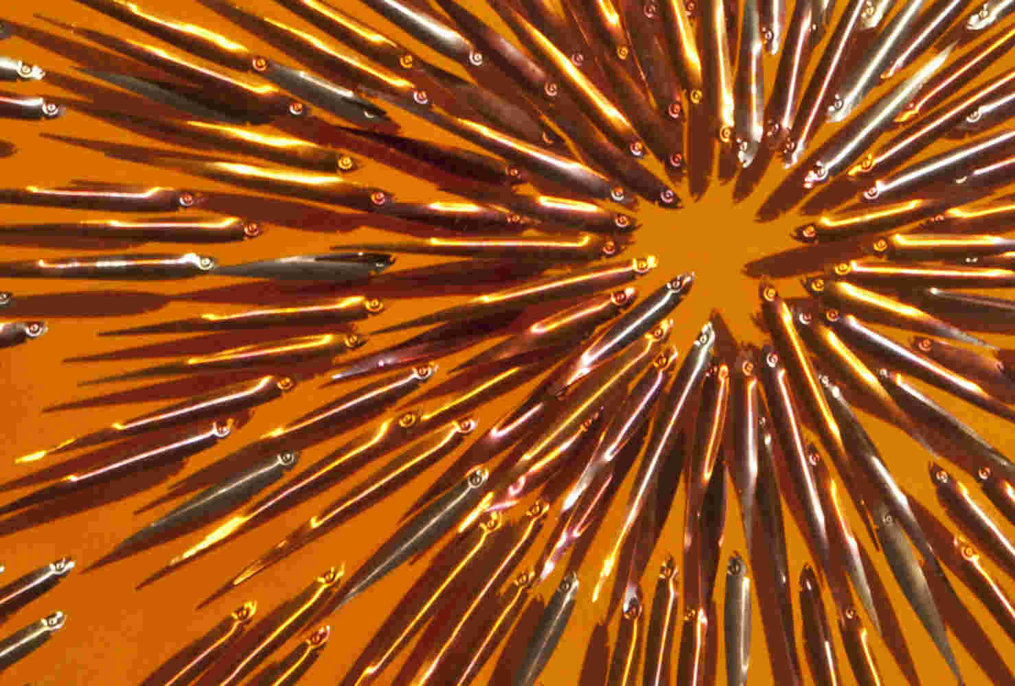 Three-dimensional wall sculpture, school of fish theme, with layers of plexiglass, aluminum frame and exploding copper fish.